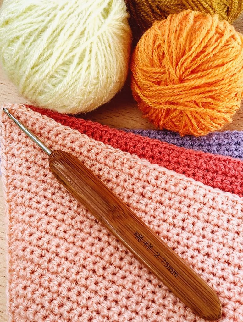 Materiales para tejer guirnalda al crochet Aguja de crochet y ovillos de hilo utilizados para tejer una guirnalda de banderines